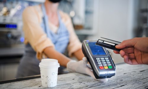 Contactless payment with debit card, coffee shop open after lockdown. Midsection.